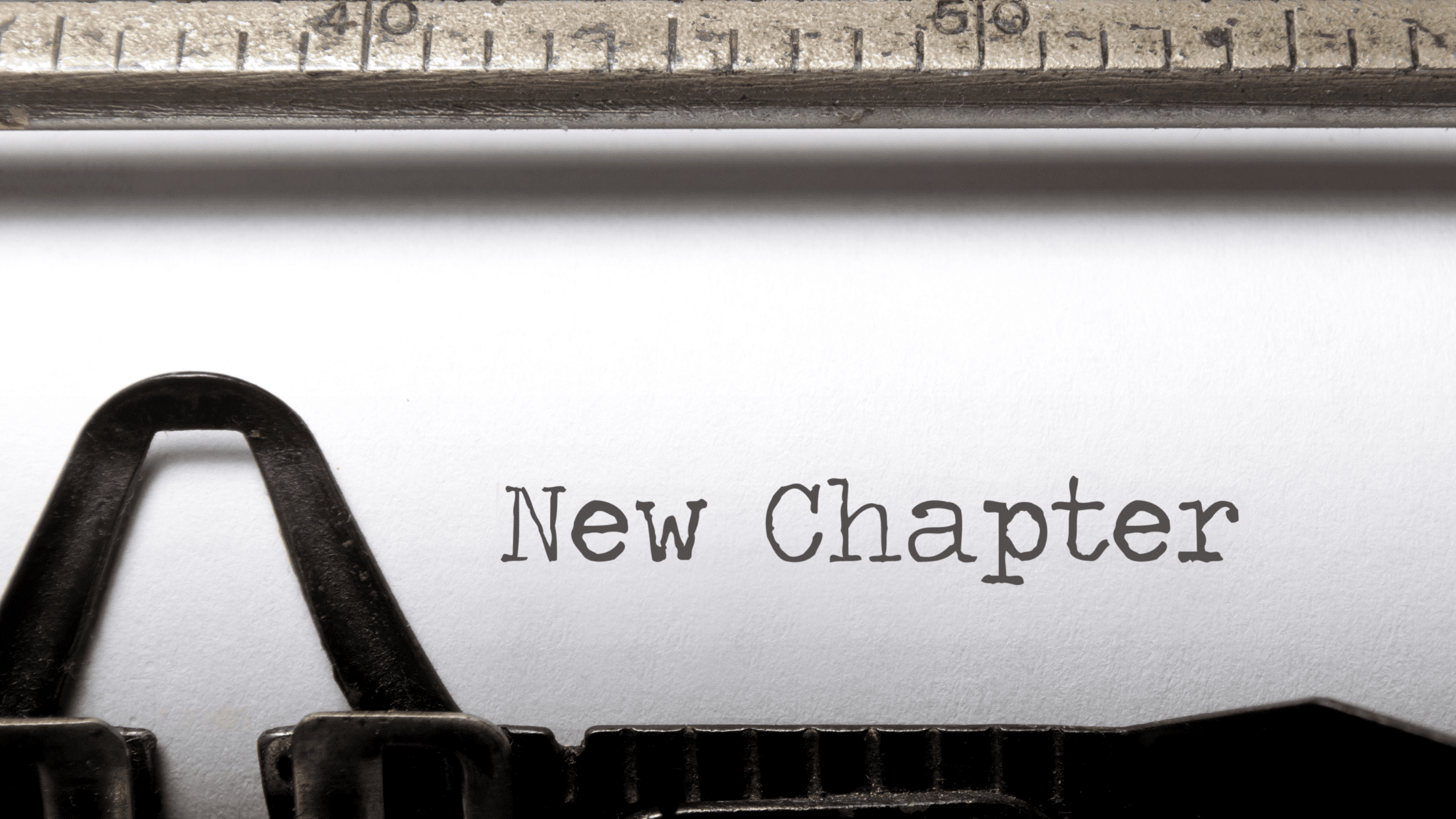 Paper in typewriter reading 'New Chapter'
