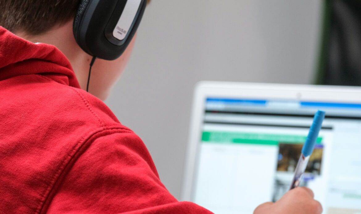 Student on laptop with headphones